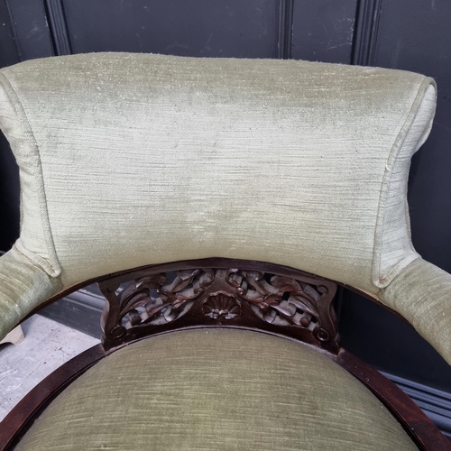 1054 - A pair of circa 1900 walnut and upholstered tub chairs.