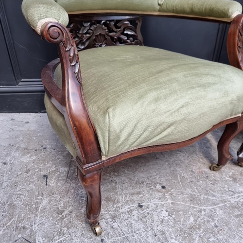 1054 - A pair of circa 1900 walnut and upholstered tub chairs.