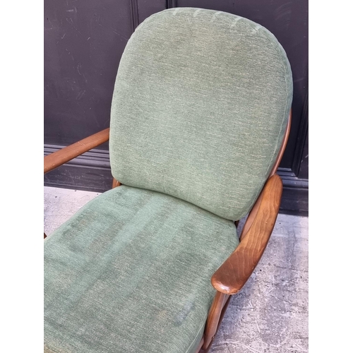 1055 - A pair of Ercol 203 armchairs, with gold stickers.