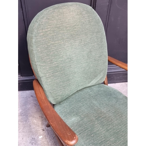 1055 - A pair of Ercol 203 armchairs, with gold stickers.