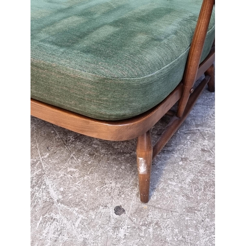 1055 - A pair of Ercol 203 armchairs, with gold stickers.