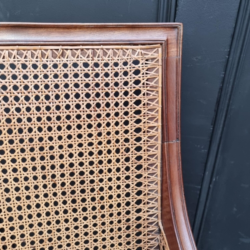 1058 - A Regency mahogany and cane bergere chair.