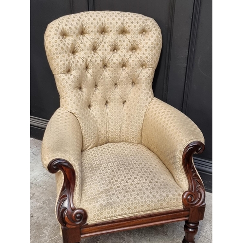 1059 - A Victorian carved rosewood and button upholstered occasional armchair, the brass casters stamped 'L... 