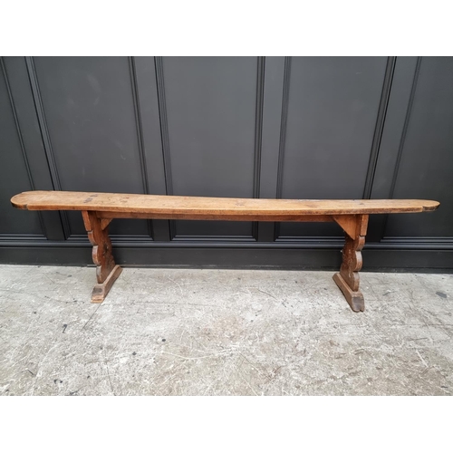 1067 - A 19th century pine long bench, one trestle stamped 'Deslandes', 199.5cm long.