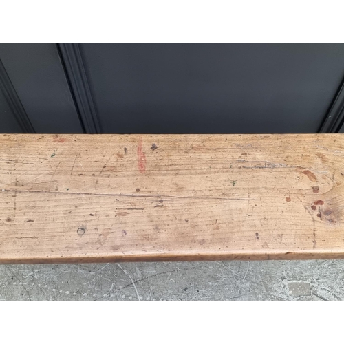 1067 - A 19th century pine long bench, one trestle stamped 'Deslandes', 199.5cm long.