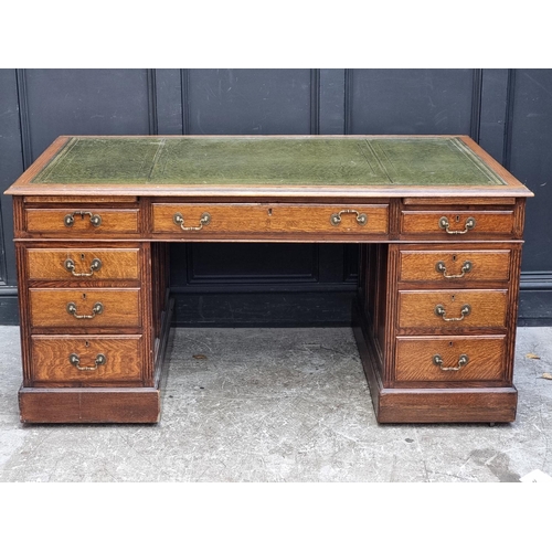 1069 - An Edwardian oak pedestal desk, 152cm wide.