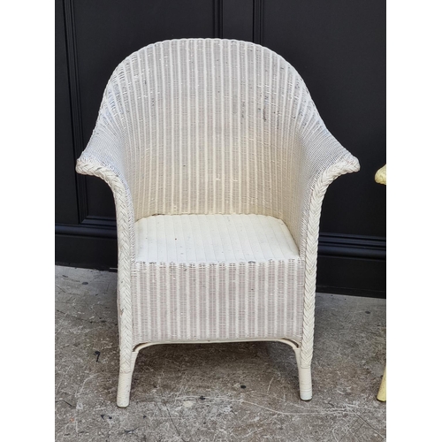 1076 - An old white painted Lloyd Loom chair.