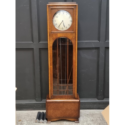 1080 - An Art Deco oak longcase clock, 191.5cm high, with pendulum and three chrome weights.... 