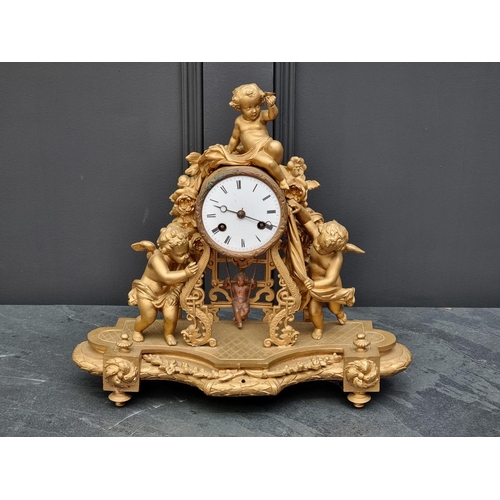 1083 - A gilt painted spelter mantel clock, 38.5cm wide, with pendulum.