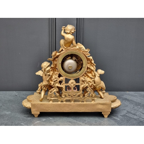 1083 - A gilt painted spelter mantel clock, 38.5cm wide, with pendulum.