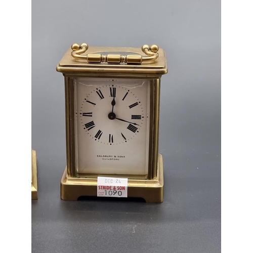 1090 - An old brass carriage timepiece, height including handle 14cm; together with another brass mantel ti... 