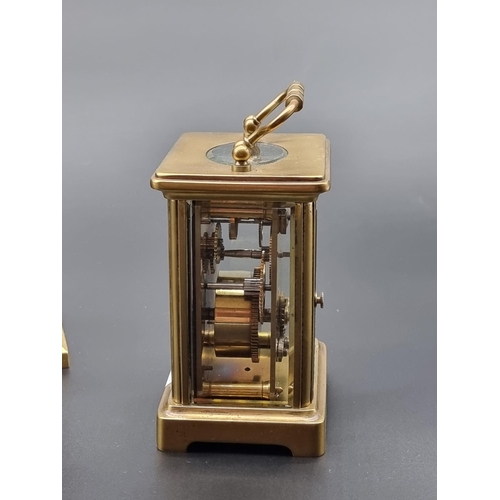 1090 - An old brass carriage timepiece, height including handle 14cm; together with another brass mantel ti... 