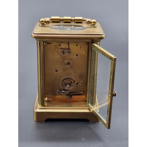 1090 - An old brass carriage timepiece, height including handle 14cm; together with another brass mantel ti... 