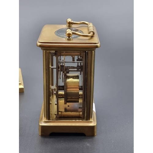 1090 - An old brass carriage timepiece, height including handle 14cm; together with another brass mantel ti... 