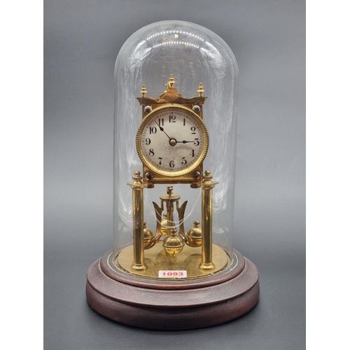 1093 - A brass anniversary timepiece, with glass dome, 32.5cm high.