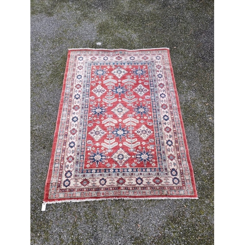 1101 - A Persian rug, having floral and geometric decoration, 208 x 155cm. 