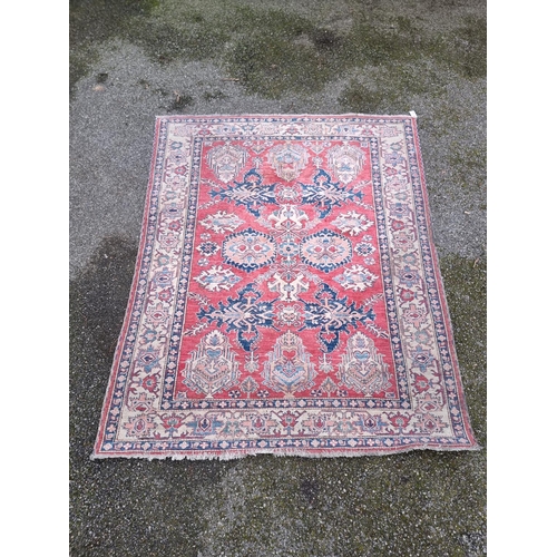 1103 - A Tribal design rug, having geometric and floral borders, 218 x 175cm.