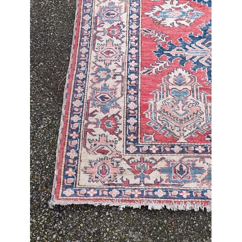 1103 - A Tribal design rug, having geometric and floral borders, 218 x 175cm.