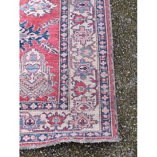 1103 - A Tribal design rug, having geometric and floral borders, 218 x 175cm.