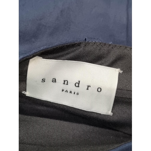 1259 - Sandro: a pair of navy chinos, with waist tabs; together with a pair of cream linen trousers by... 