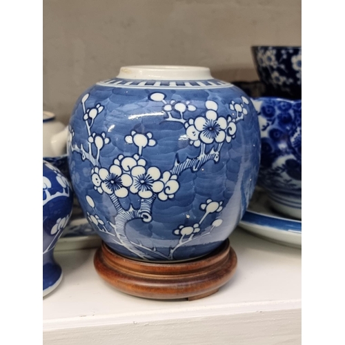 1339 - A collection of Chinese and Japanese blue and white porcelain; together with two hardwood stand... 