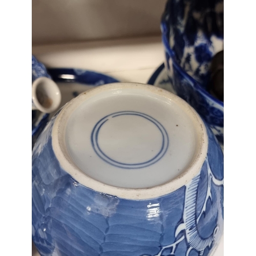 1339 - A collection of Chinese and Japanese blue and white porcelain; together with two hardwood stand... 