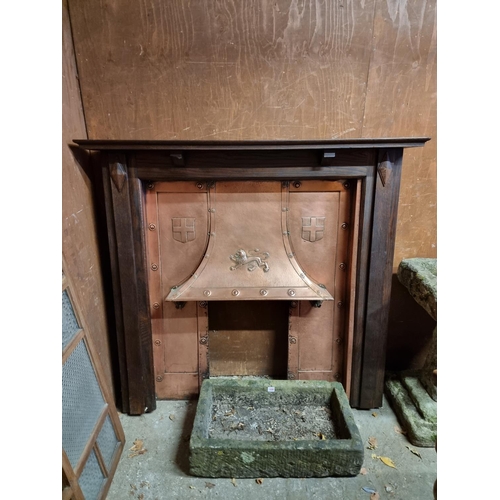 1694 - An oak and copper fireplace, the aperture of oak surround 111 x 97cm.