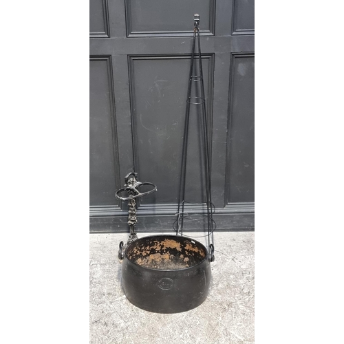 1698 - A cast iron stick stand; together with another cast iron cauldron, 52cm wide; and a wirework garden ... 