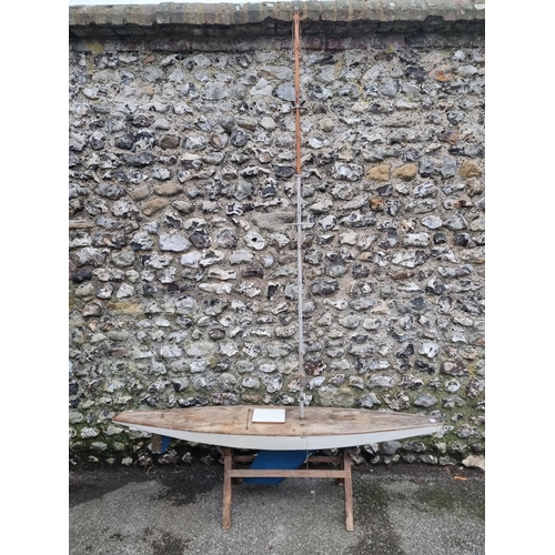 1702 - A large vintage pond yacht, the hull 169.5cm long, on pine stand.