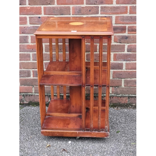 1077 - A ewe and inlaid revolving bookcase, 49cm wide.