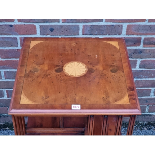 1077 - A ewe and inlaid revolving bookcase, 49cm wide.