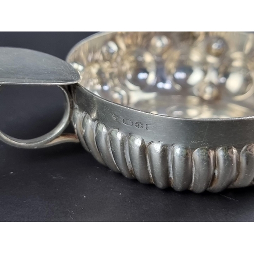 28 - A silver taste du vin, by Garrard & Co Ltd, import mark London, 10cm wide, 67g.