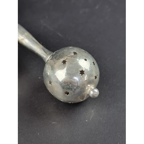 38 - An unusual silver cowbell child's rattle, marks rubbed, gross weight 38g.