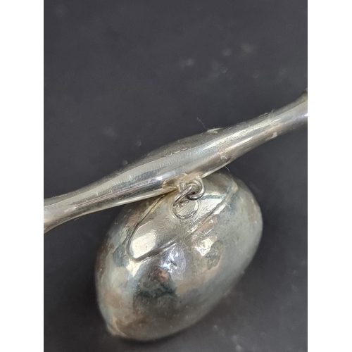 38 - An unusual silver cowbell child's rattle, marks rubbed, gross weight 38g.