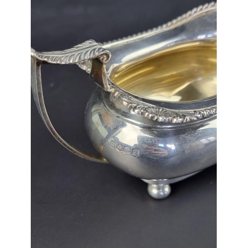 4 - A silver twin handled sugar bowl and matching milk jug, by James Deakin & Sons, Sheffield 1... 