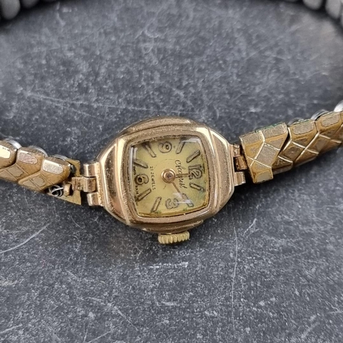 425 - An Accurist 9ct gold ladies wristwatch, with gold plated expanding strap: together with a carved she... 