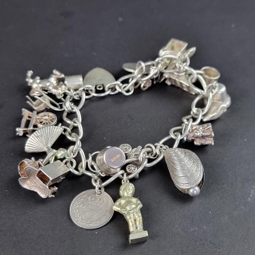 436 - Two bracelets, one with a padlock clap with twenty six attached charms and coins, some stamped 800 o... 