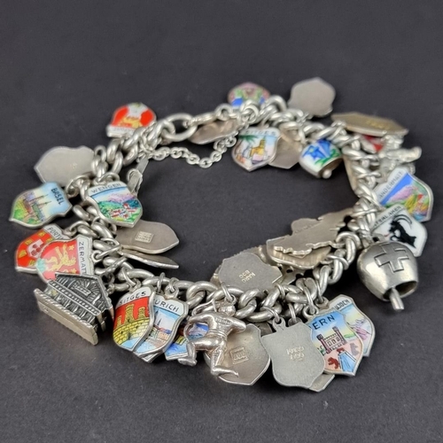 437 - Two similar bracelets, with approximately fifty seven attached charms and and enamel decorated crest... 