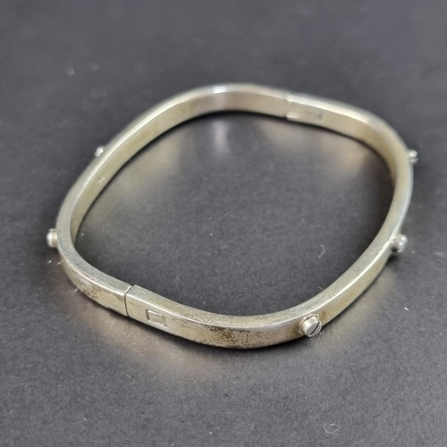 438 - A modern white metal bangle, stamped 925.