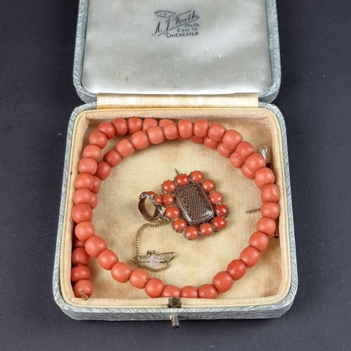 471 - A Victorian coral single strand bead necklace, having 56 semi round beads fastened with a yellow met... 