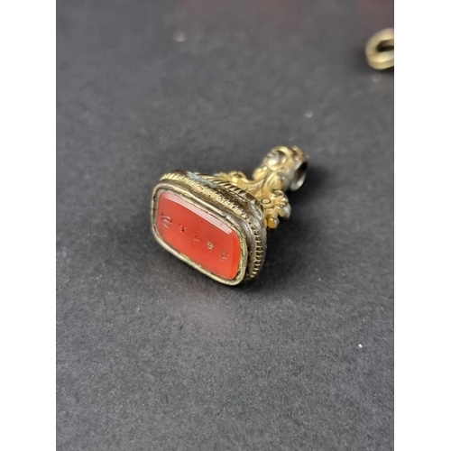 502 - A 19th century carved coral Figa hand pendant, 30mm; and two other items.