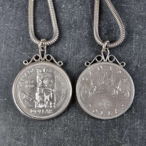 527 - Coins: two Canada silver dollars, 1953 and 1958, in pendant mounts with chains.