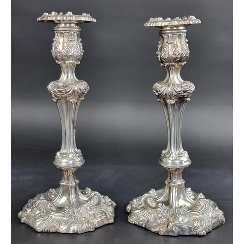 63 - A pair of William IV silver candlesticks, I.W, Sheffield 1834 and 1837, 28cm high, weighted.... 