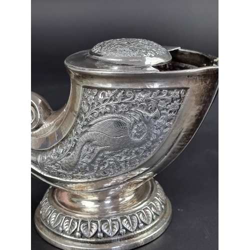 66 - A Persian white metal nautilus shell spoon warmer, 11.5cm high.