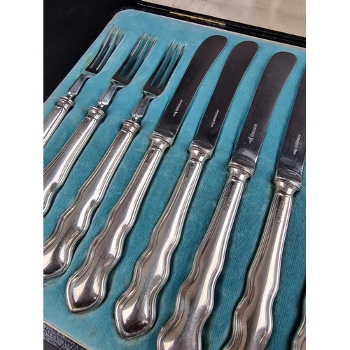 68 - A cased set of twelve silver handled fruit knives and forks, by Walker & Hall, Sheffield, forks ... 