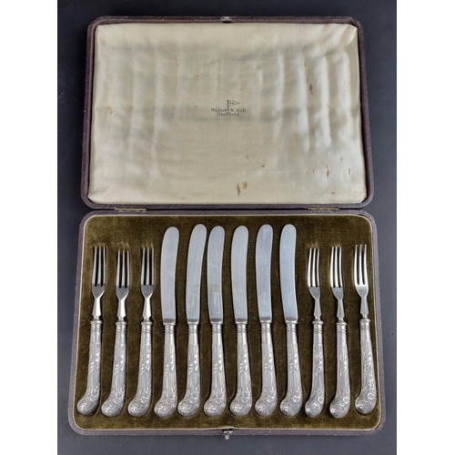 69 - A cased set of twelve silver pistol grip fruit knives and forks, by Walker & Hall, the handles h... 