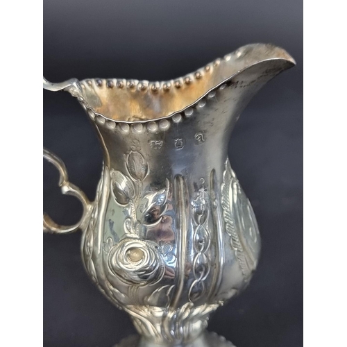 9 - A George III cream jug, maker's mark rubbed, London 1776, (having later decoration), height to handl... 