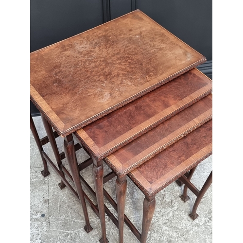 1002 - A nest of 1930s walnut and crossbanded quartetto tables, largest 56cm wide.