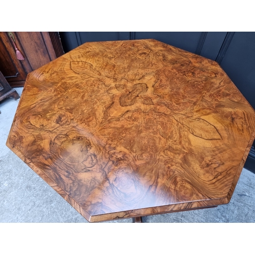 1023 - A Victorian walnut octagonal centre table, with well figured quarter veneered top, 99cm wide.... 