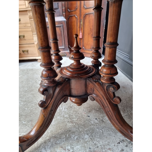 1023 - A Victorian walnut octagonal centre table, with well figured quarter veneered top, 99cm wide.... 